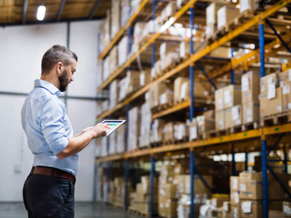 Man checking packages in warehouse