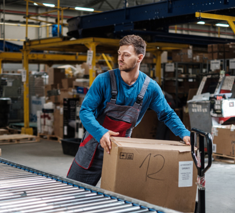 Warehouse worker moving package